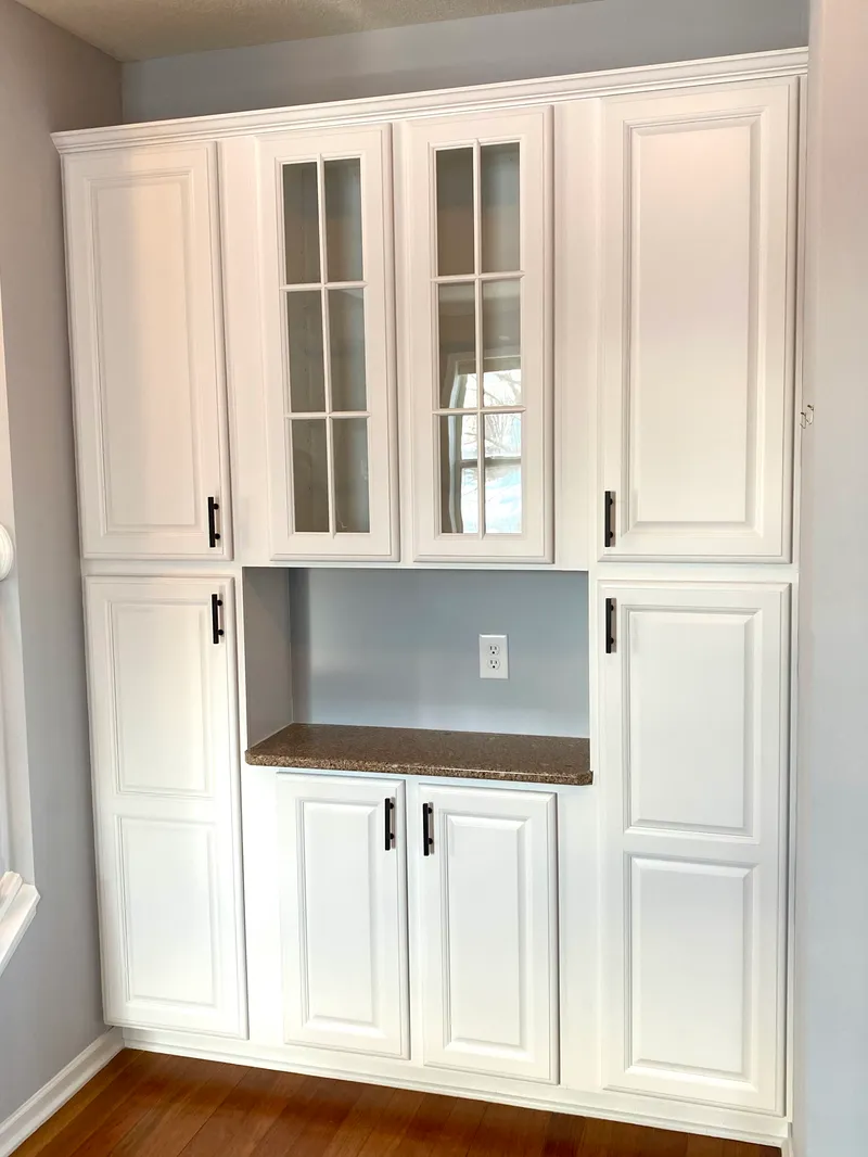 The same built-in cabinets painted white