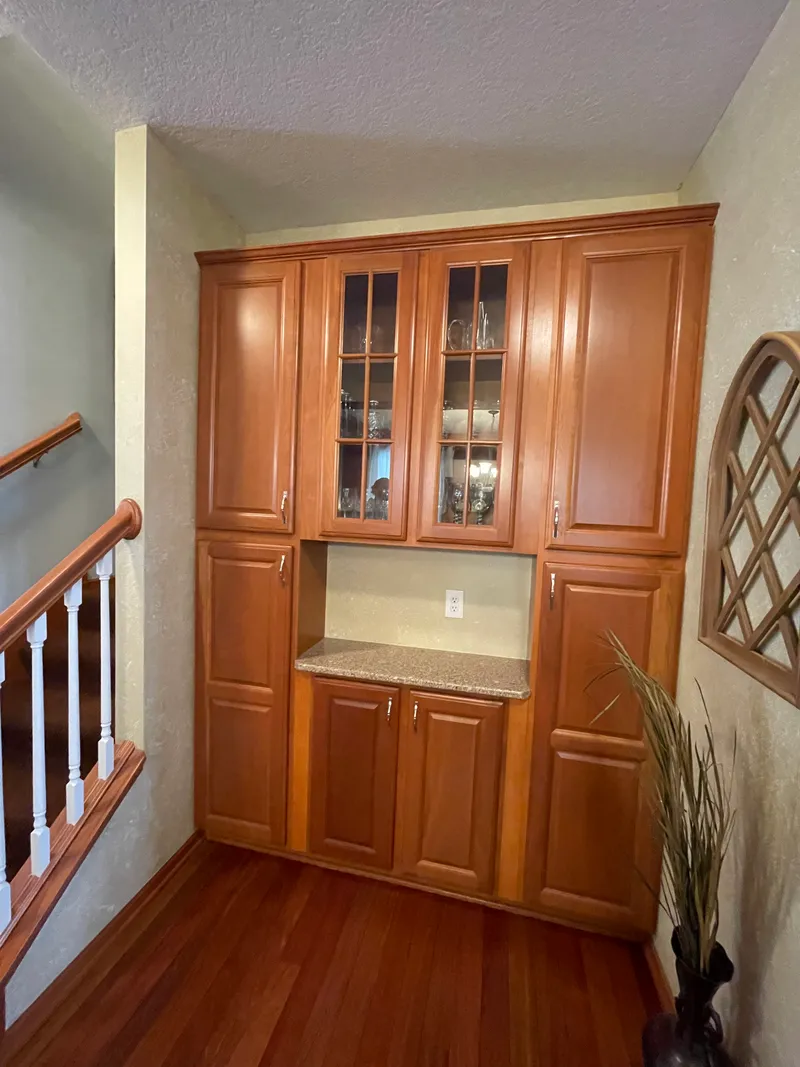 Built-in cabinets with a wood-stained finish before painting