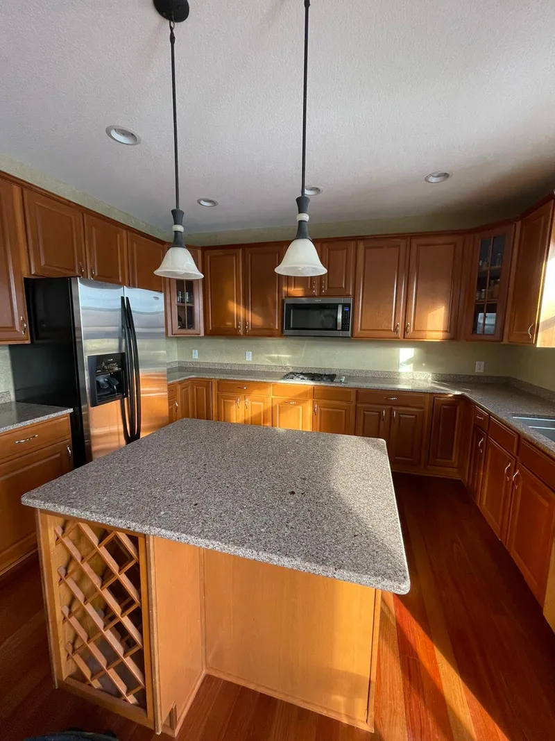 Kitchen with wood-stained cabinets before painting