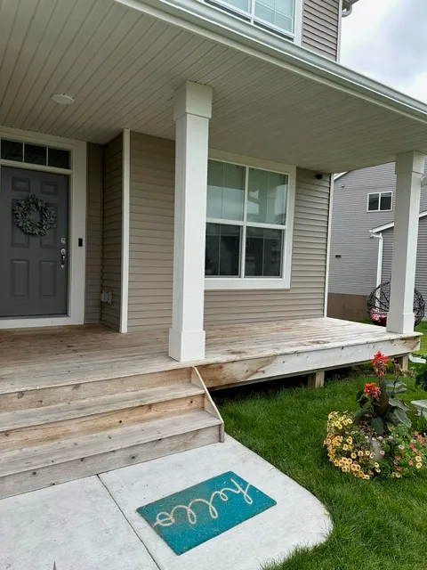 Front porch with bare wood decking and steps before painting