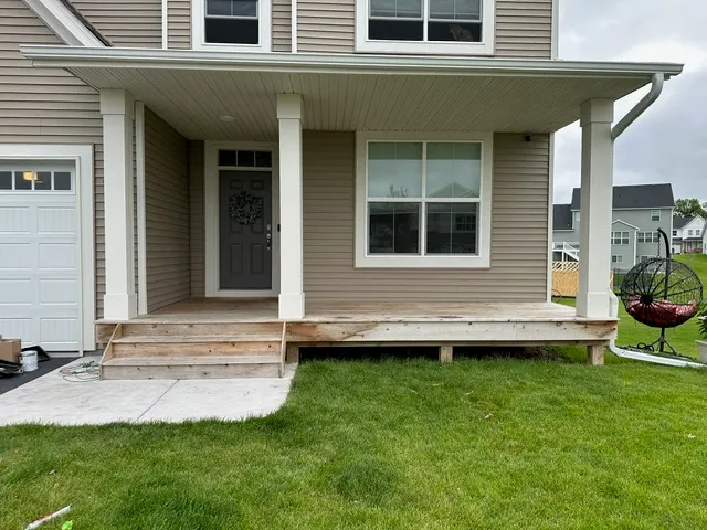 Front porch with bare wood decking before painting